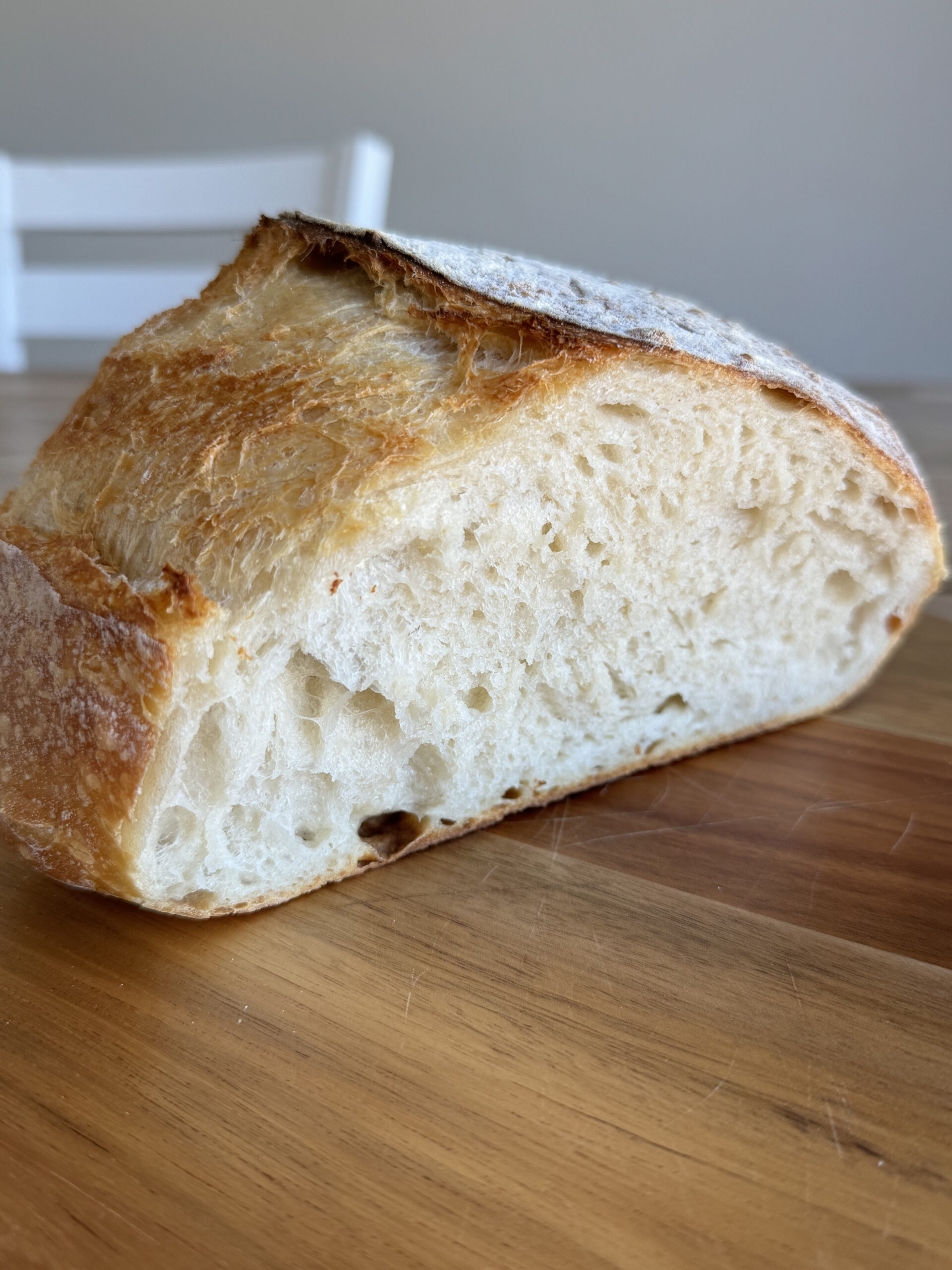 loaf of sourdough bread cut in half on a cutting board