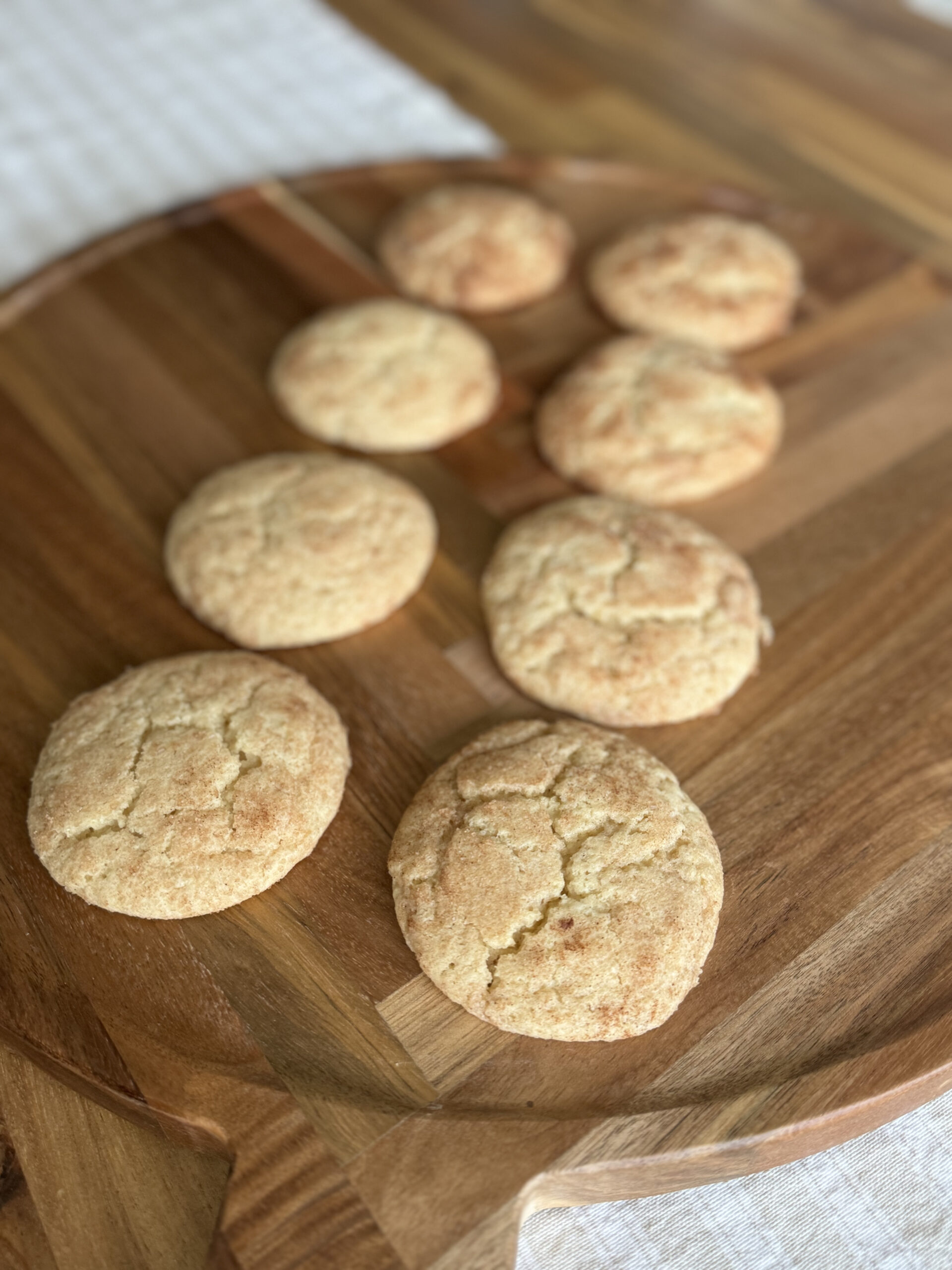 snickerdoodle cookies baked and on a wooden cutting board