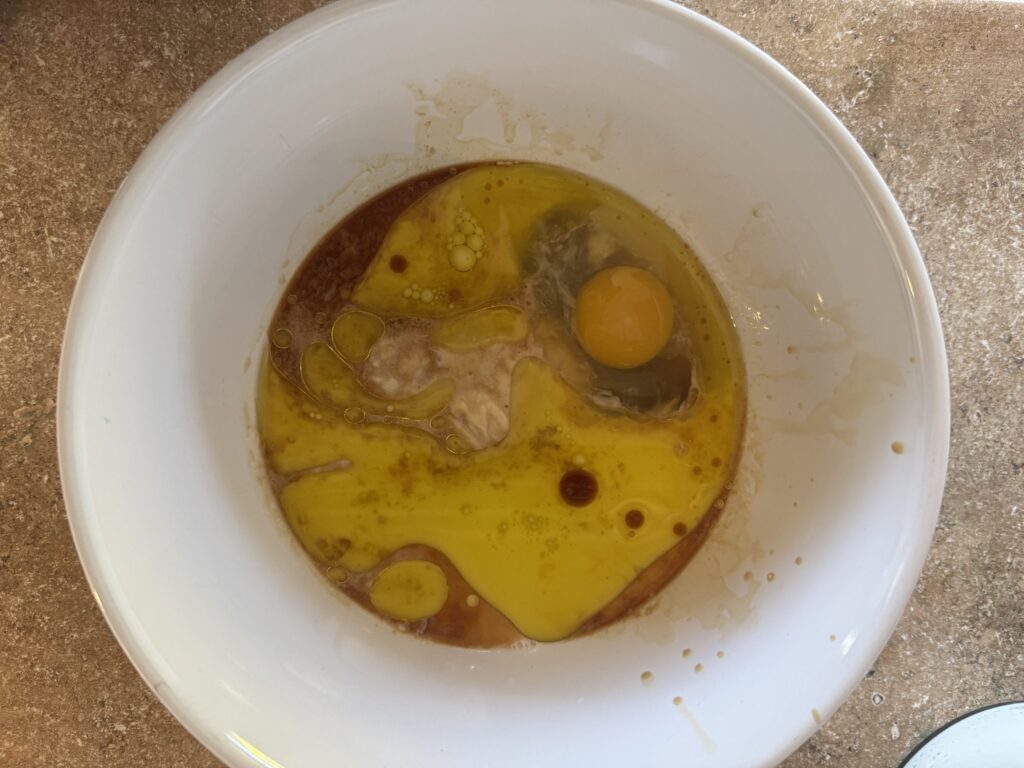 a bowl of wet ingredients for making blueberry muffins.