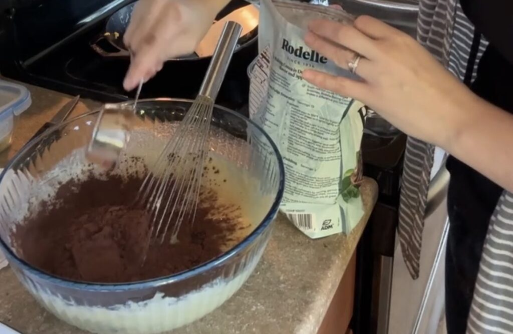 a glass bowl, mixing ingredients for the sourdough brownie batter.