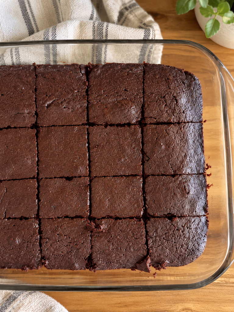 a pan of sourdough brownies, cut into squares on a table with a linen cloth for decoration